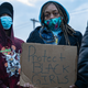 Vigil attendee holds a sign advocating to protect Black girls in Columbus, Ohio on April 21, 2021. The vigil was for Ma’Khia Bryant, 16, who was shot and killed by Columbus Police on April 20, 2021.The vigil was attended by activists and friends and family of Ma’Khia.
